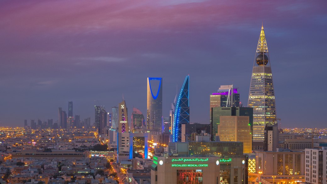 Riyadh skyline at dusk, with Kingdom Centre, Al Faisaliah Tower and illuminated city streets